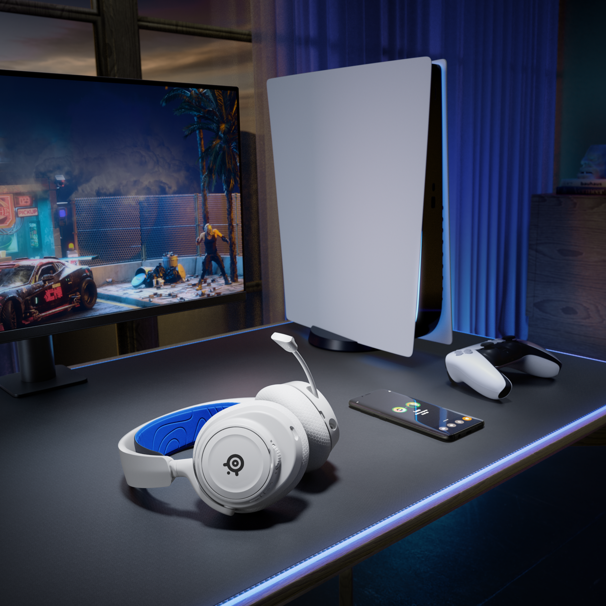 Gaming setup with headset, console, controller, and phone