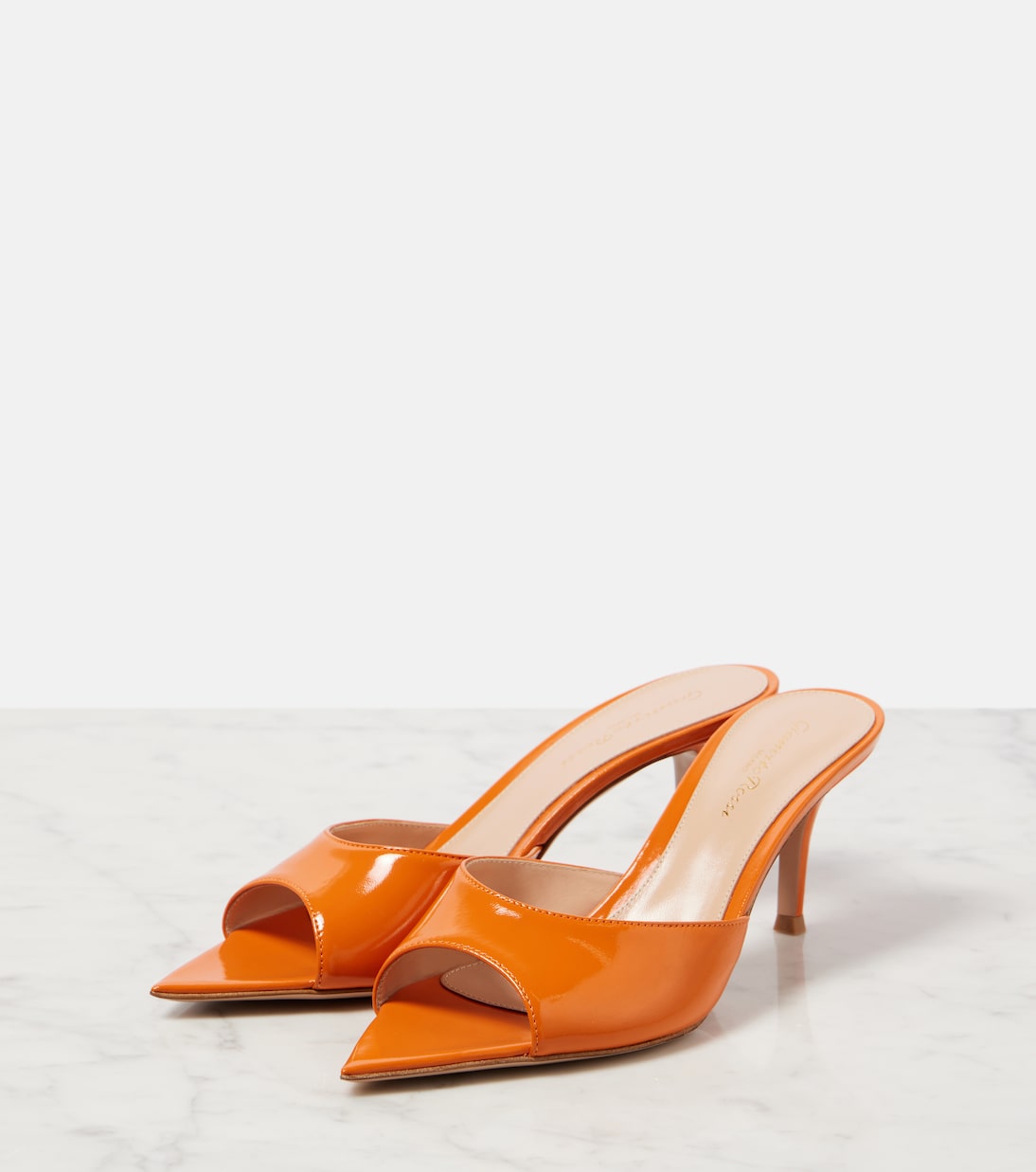 Pair of orange patent leather high-heeled mules