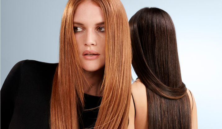 Two women with long straight red and black hair