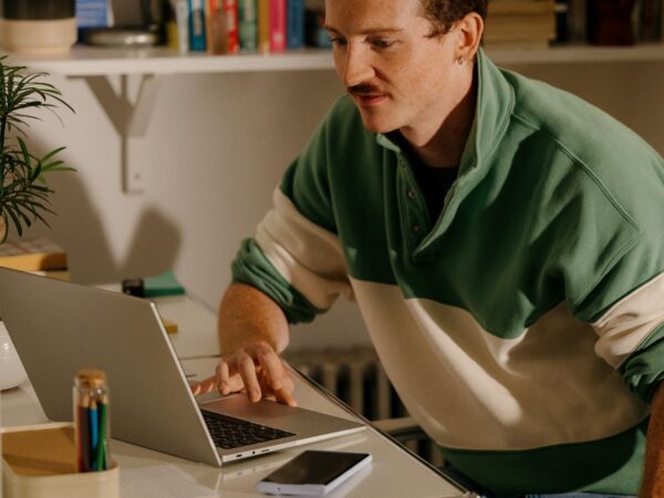 Young man working on laptop at desk