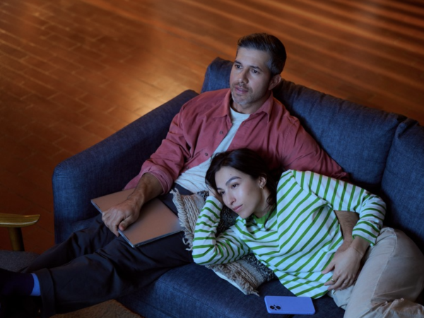 Couple relaxing together on blue couch indoors