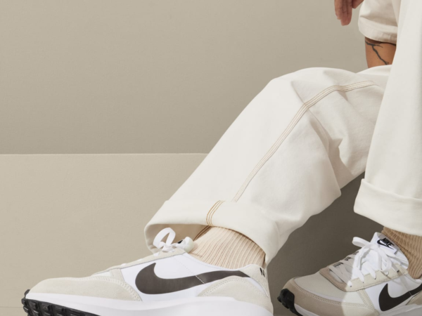 Person wearing white Nike sneakers and cream pants