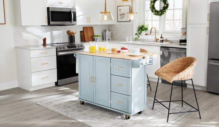 Bright kitchen with blue island, wicker chair