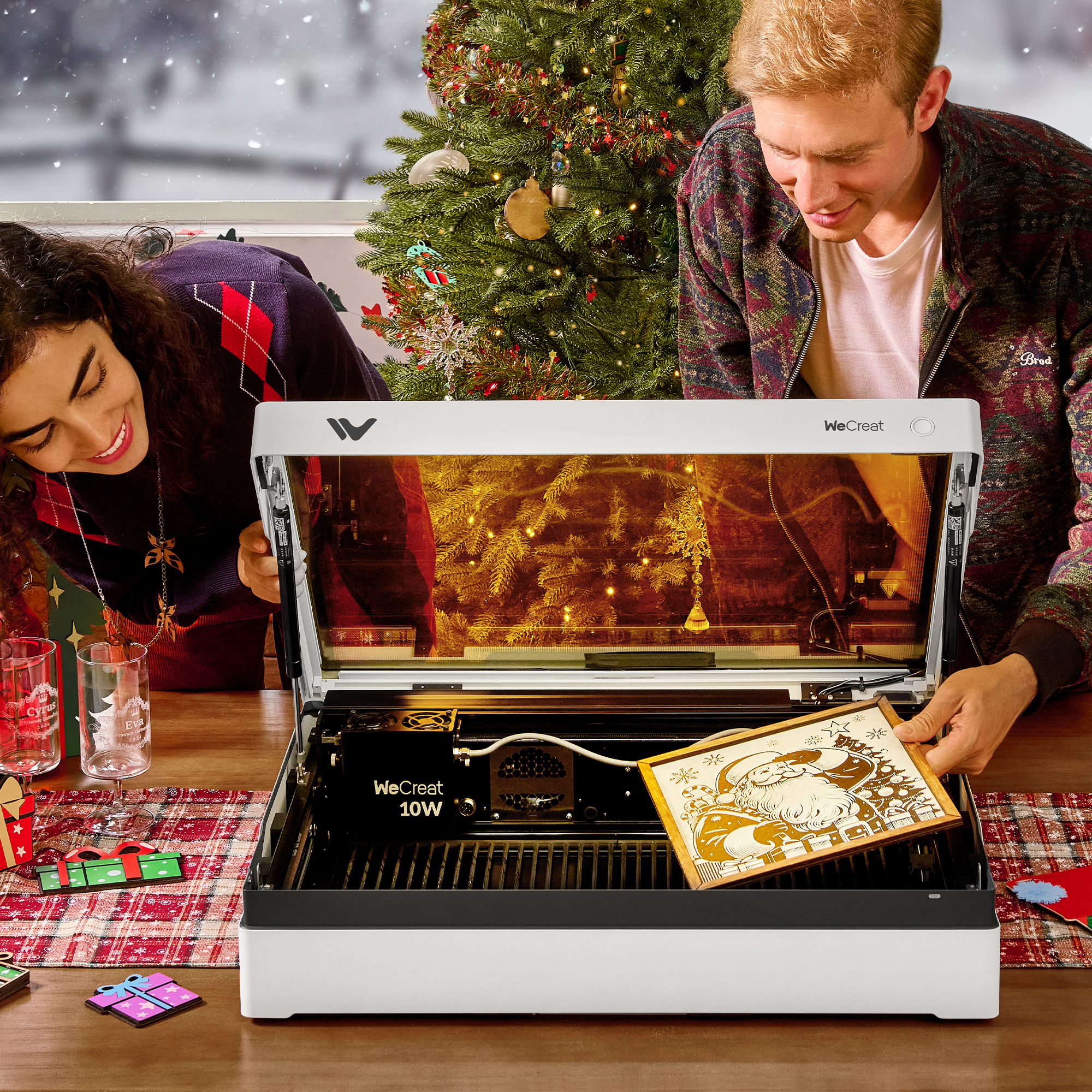 Couple using WeCreat laser engraving machine Christmas scene