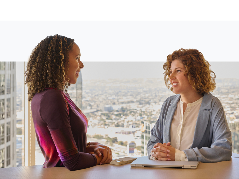 Two women having a conversation in office
