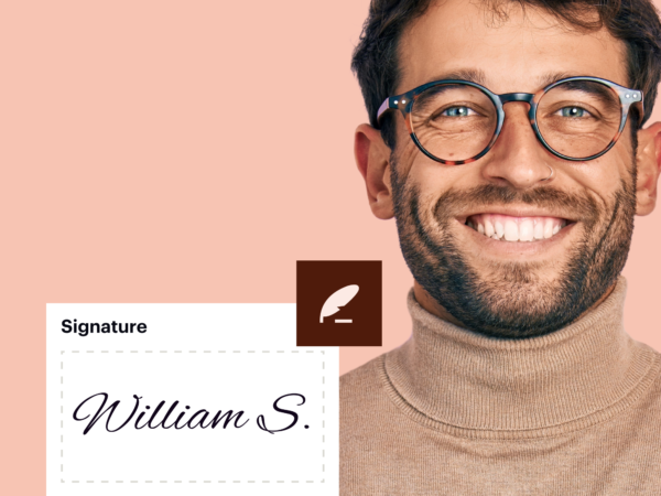 Smiling man wearing glasses and beige turtleneck