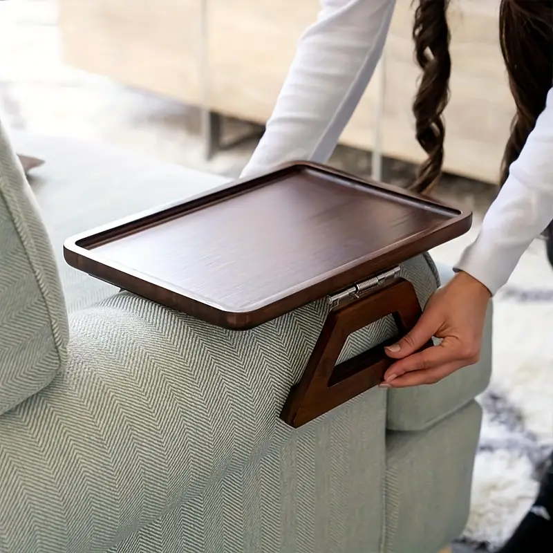 Wooden adjustable armrest tray on sofa