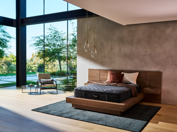 Modern bedroom with wooden bed and large glass windows