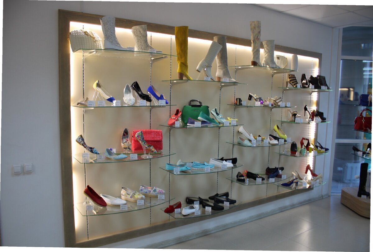 Glass shelves with women's shoes and bags