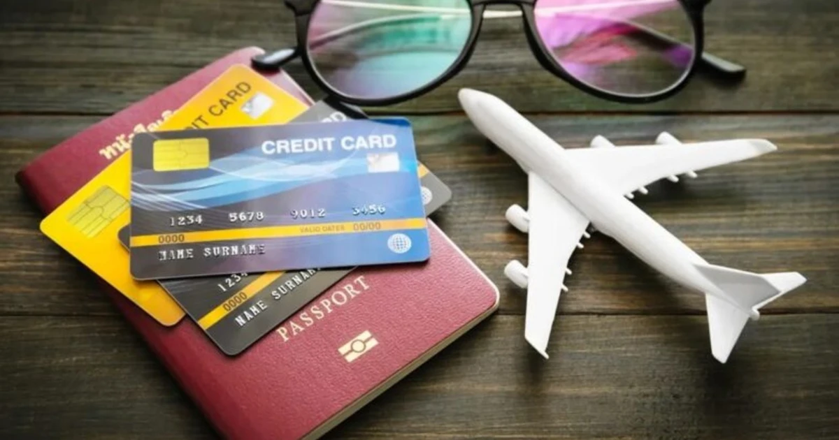 Travel essentials: passport, credit cards, toy airplane, sunglasses