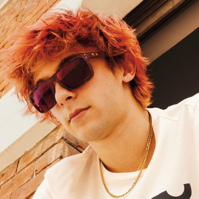 Young man with red hair wearing sunglasses and white shirt