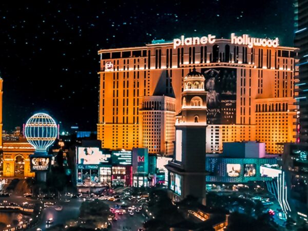 Planet Hollywood hotel lit up at night with city traffic