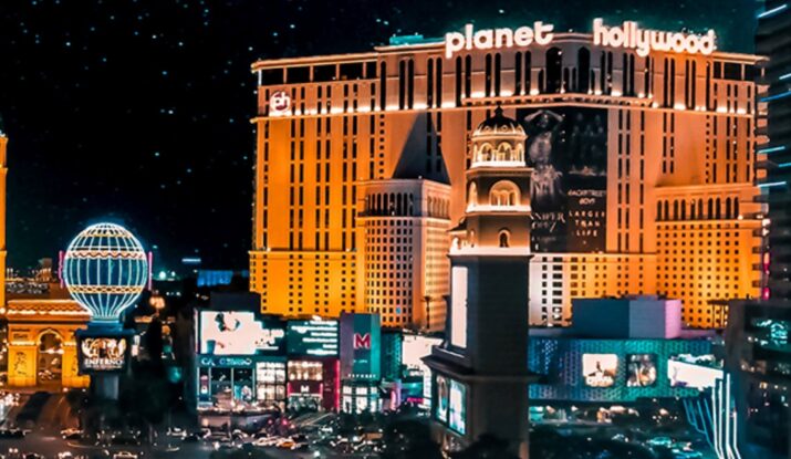 Planet Hollywood hotel lit up at night with city traffic