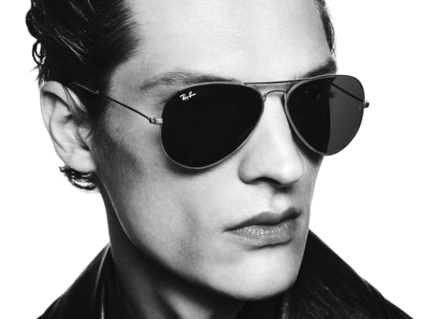 Man wearing Ray-Ban aviator sunglasses and leather jacket