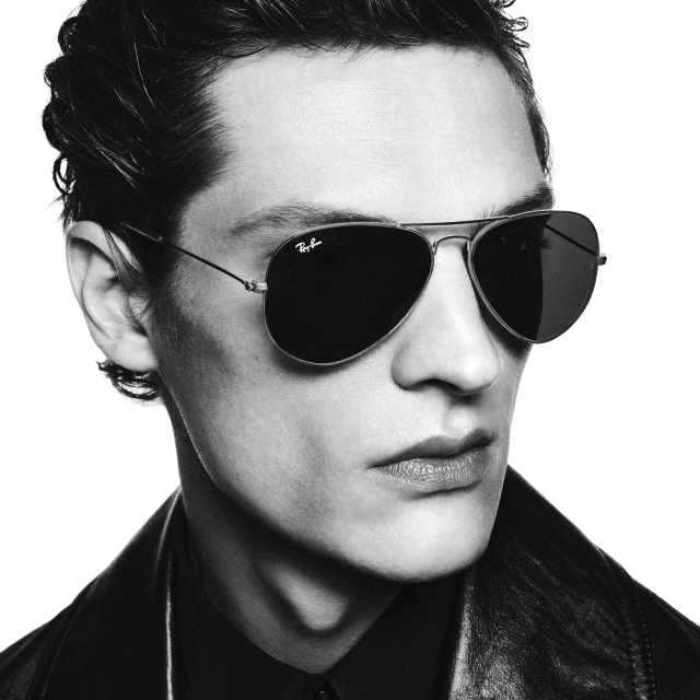 Man wearing Ray-Ban aviator sunglasses and leather jacket