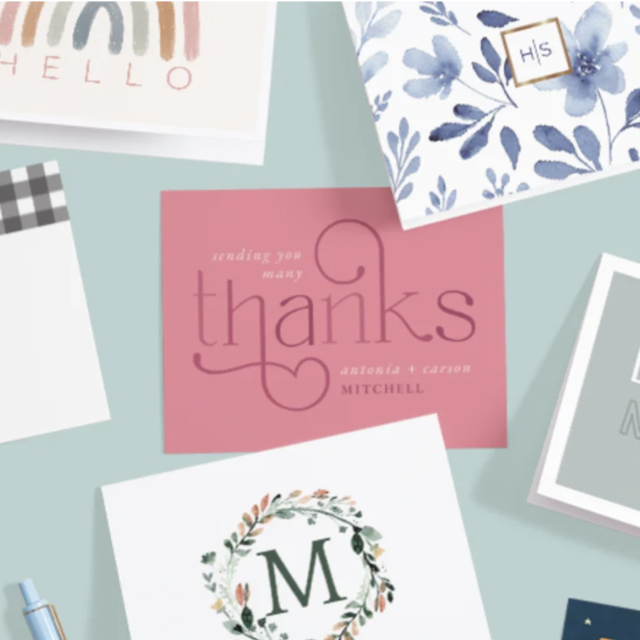Assorted personalized greeting and thank you cards on table