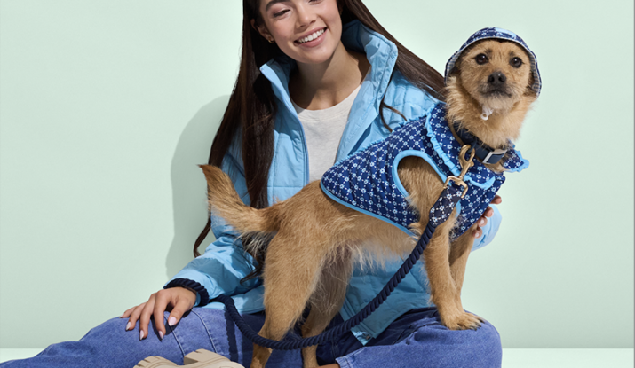 Woman in blue jacket with dog in matching coat