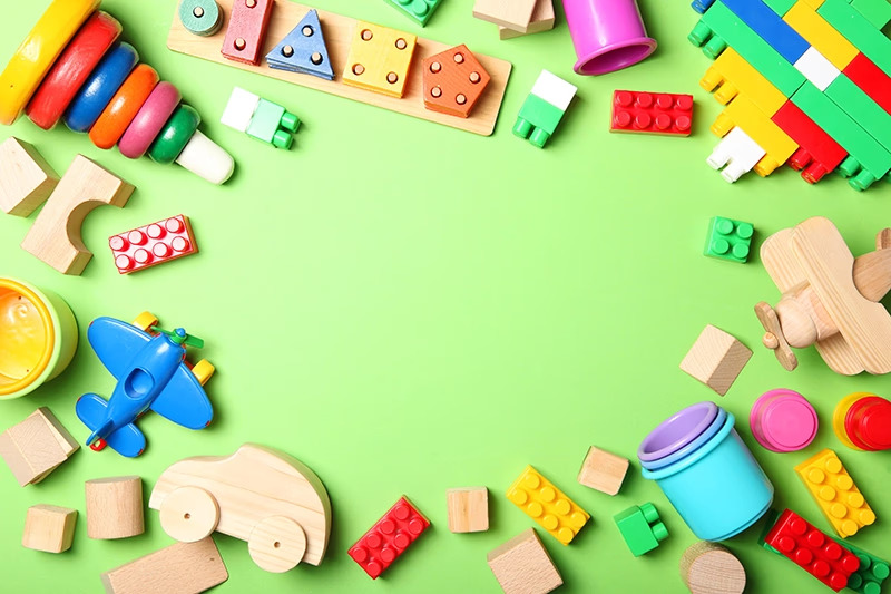 Colorful children's toys scattered on green surface