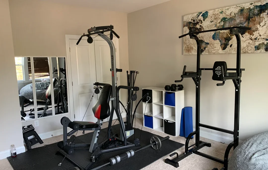 Home gym with weight machine and pull-up bars