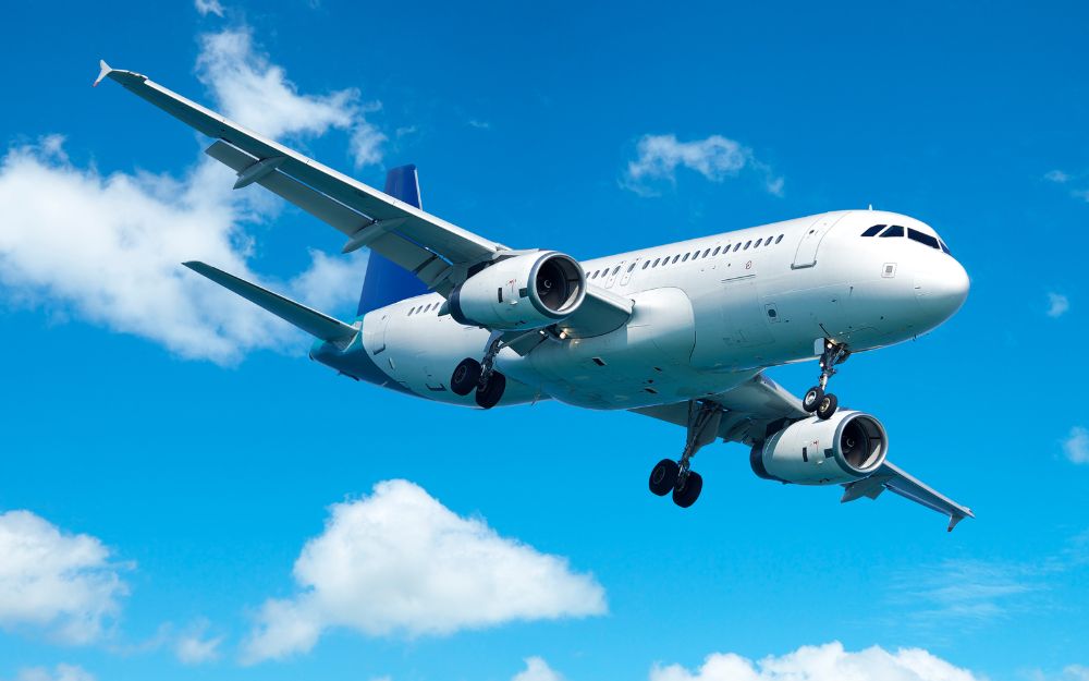 Commercial airplane flying against blue sky