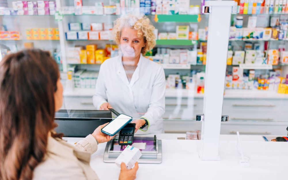 Customer paying with phone at pharmacy counter