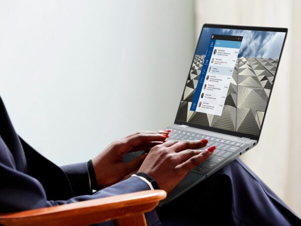 Person typing on laptop with chat messages open