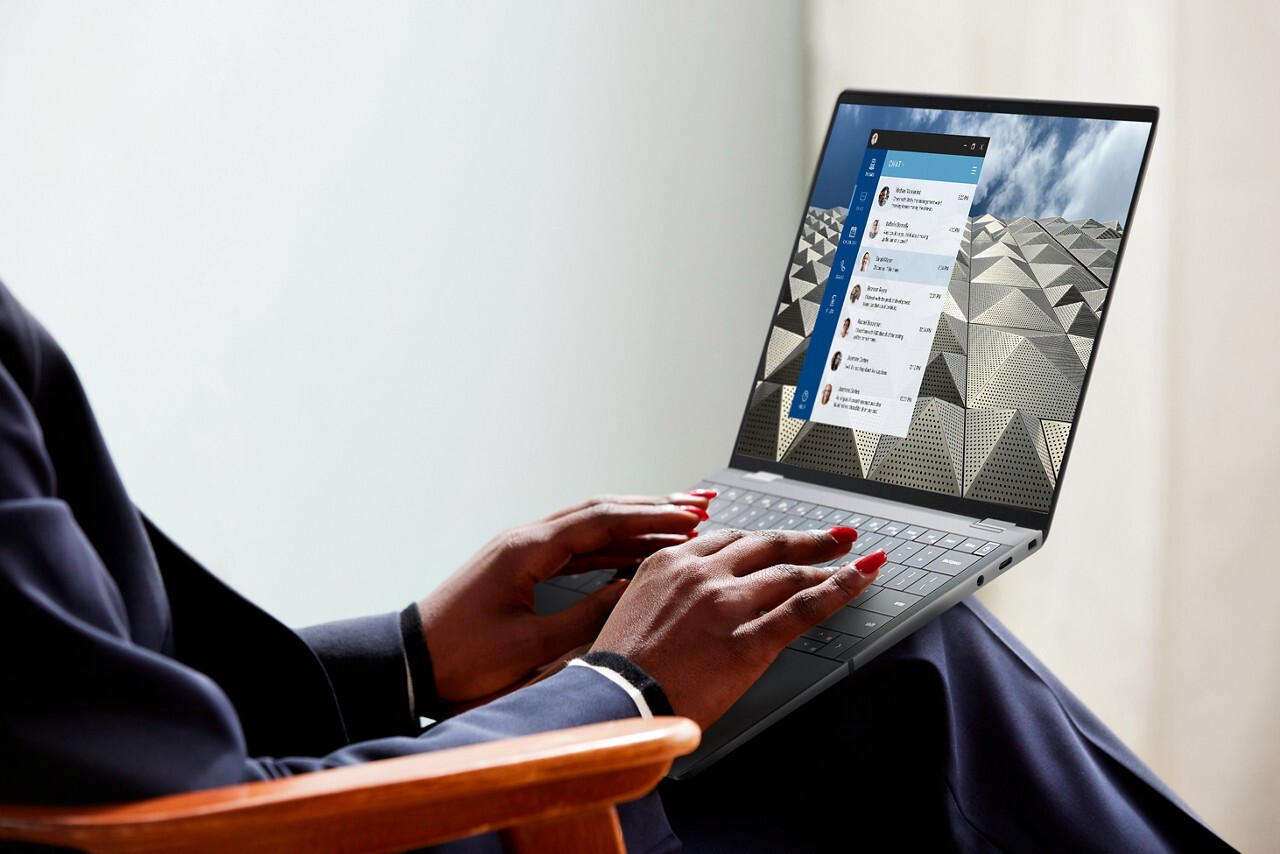 Person typing on laptop with chat messages open