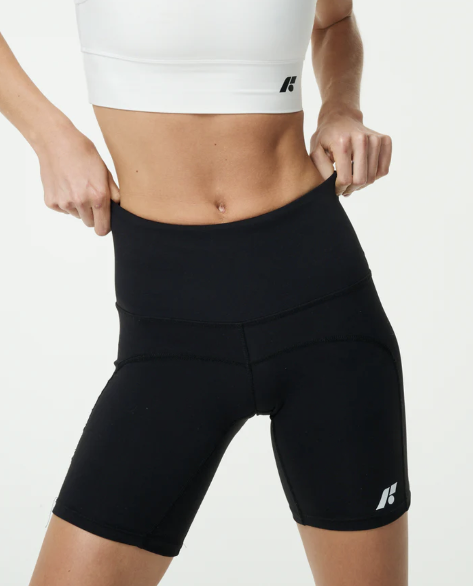 Person wearing high-waisted black athletic shorts