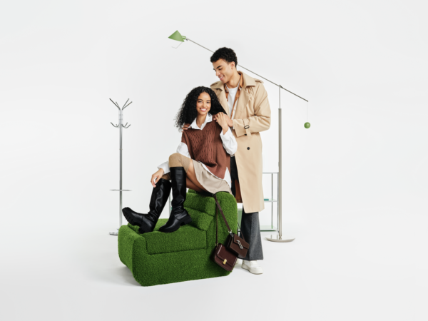Couple posing with green textured chair and floor lamp