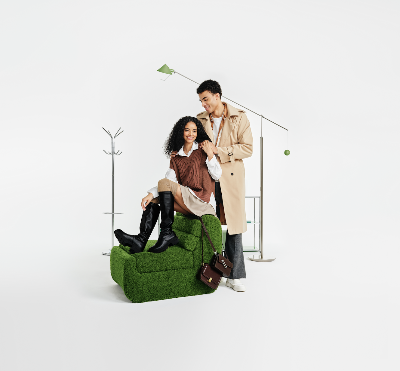 Couple posing with green textured chair and floor lamp