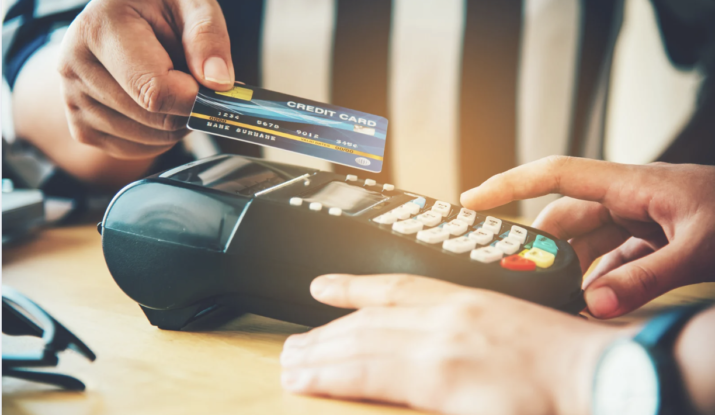 Person paying with credit card on payment terminal