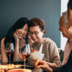 Family celebrating together with wine and flowers