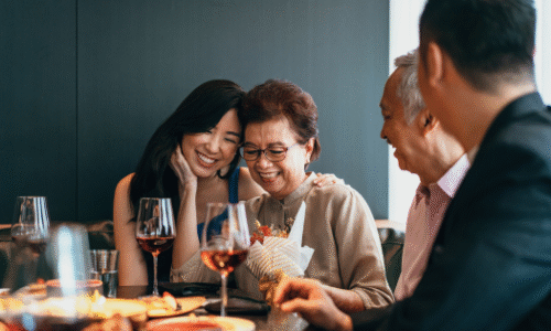 Family celebrating together with wine and flowers