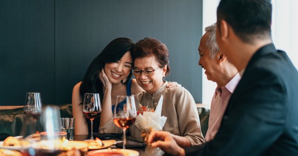 Family celebrating together with wine and flowers