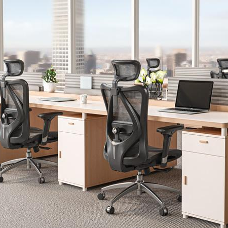 Modern office workspace with ergonomic chairs and laptops