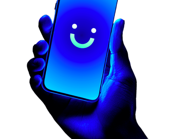 Hand illuminated in blue light holding a smartphone with a bright blue screen displaying a simple smiley face icon.