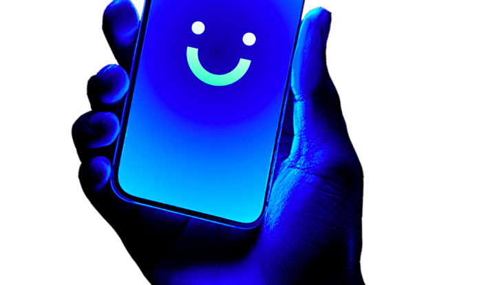 Hand illuminated in blue light holding a smartphone with a bright blue screen displaying a simple smiley face icon.