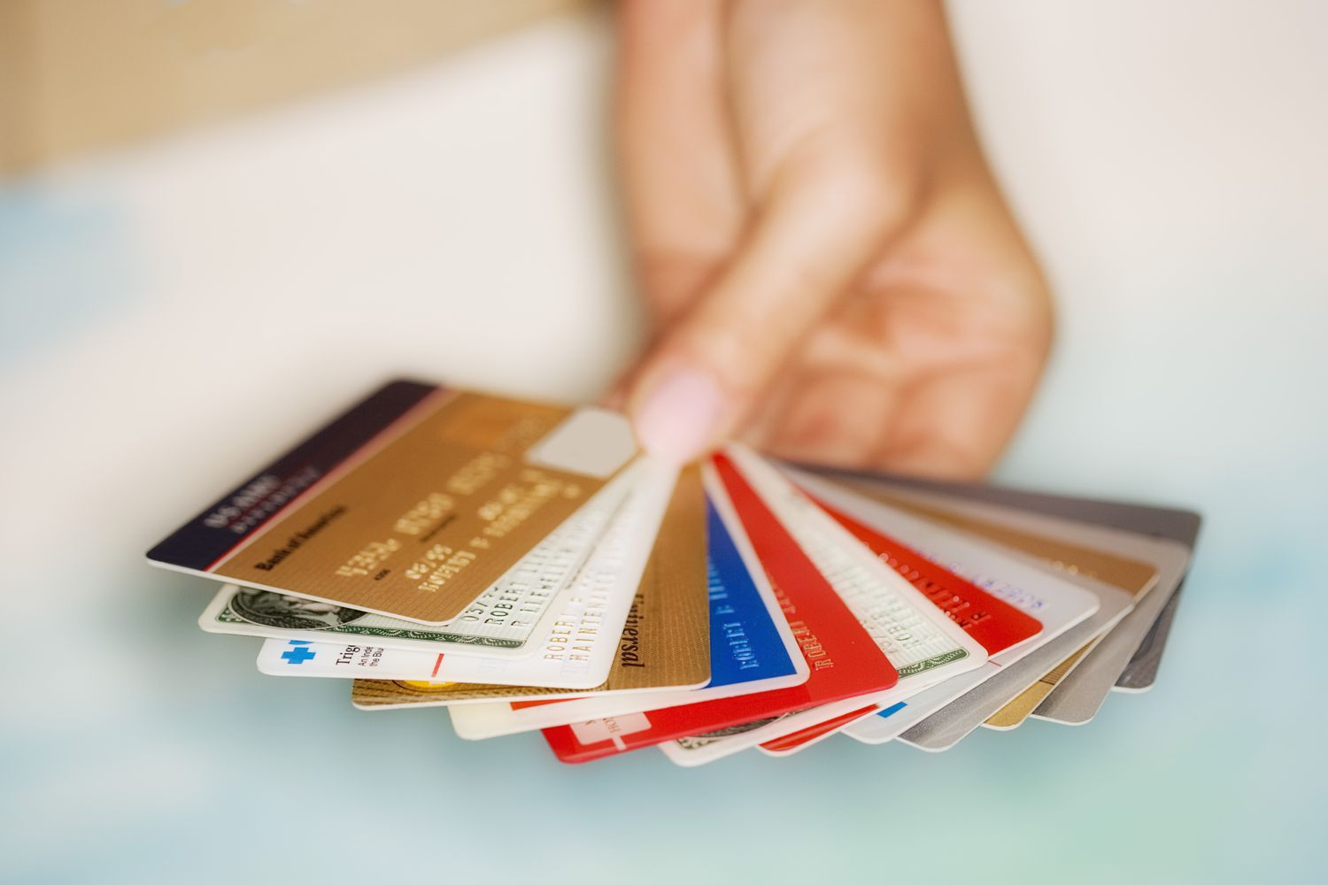 Hand holding multiple credit and membership cards