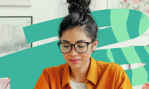 Young woman wearing orange shirt and glasses working on a laptop with abstract shapes in background