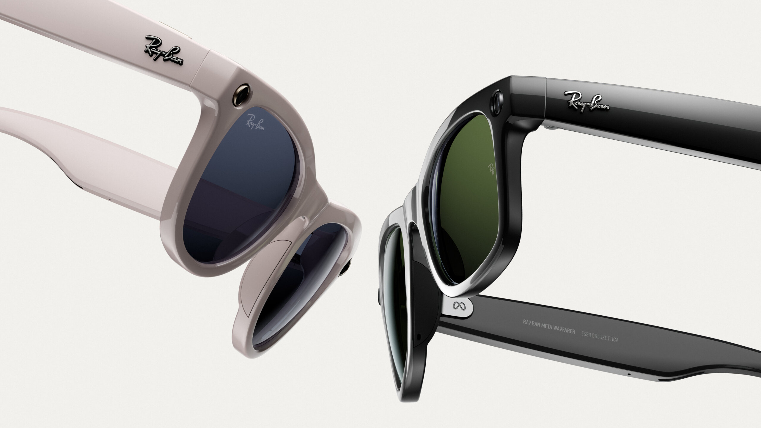 Close-up view of two pairs of Ray-Ban sunglasses, one in light beige with dark blue lenses and the other in black with dark green lenses, displayed against a plain light grey background.