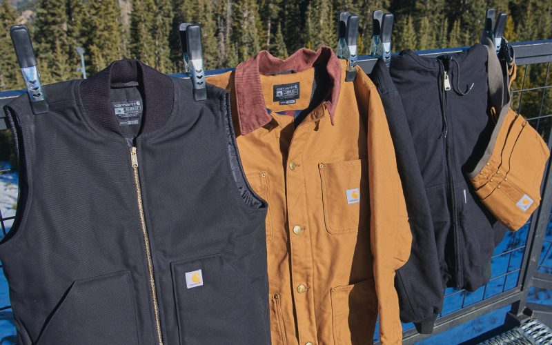 Carhartt jackets and clothing hung outdoors to dry